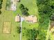 Expansive estate featuring multiple buildings, gardens, ponds, and lush greenery at 1502 Campground Rd, Mcdonough, GA 30252