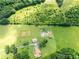 Overhead view of a home surrounded by green fields and lush trees at 1502 Campground Rd, Mcdonough, GA 30252