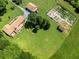 Aerial photograph highlights a home with a garden, outbuildings, and lush grounds at 1502 Campground Rd, Mcdonough, GA 30252
