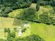 Property aerial shows home, buildings, gardens, and open fields with tree borders at 1502 Campground Rd, Mcdonough, GA 30252