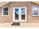 Inviting back porch with brick exterior, double doors, and a 'Welcome' mat at 1502 Campground Rd, Mcdonough, GA 30252