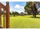 Expansive backyard with lush green grass and a brick structure, perfect for outdoor activities at 1502 Campground Rd, Mcdonough, GA 30252