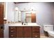 Bathroom featuring blue striped wallpaper, wood cabinets and toilet at 1502 Campground Rd, Mcdonough, GA 30252