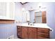 Bathroom featuring blue striped wallpaper, wood cabinets and decorative lighting at 1502 Campground Rd, Mcdonough, GA 30252