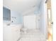 Bathroom with light blue walls, marble floors, a white vanity and tub-shower at 1502 Campground Rd, Mcdonough, GA 30252