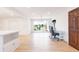 Bright dining room with hardwood flooring, large windows, white walls, and a view of the outdoor scenery at 1502 Campground Rd, Mcdonough, GA 30252