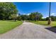 Long driveway flanked by green lawns and trees; decorative stone pillars mark the entrance at 1502 Campground Rd, Mcdonough, GA 30252