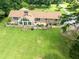 Rear exterior of brick home with spacious back yard, patio and large windows offering scenic views at 1502 Campground Rd, Mcdonough, GA 30252