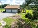 Exterior shot of the home with a two-car garage and staircase leading to the deck at 1502 Campground Rd, Mcdonough, GA 30252