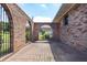 Brick-paved courtyard with brick privacy walls and gated archways creating a secluded outdoor space at 1502 Campground Rd, Mcdonough, GA 30252