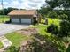 Exterior shot of the home featuring a two-car garage and staircase leading to the deck at 1502 Campground Rd, Mcdonough, GA 30252
