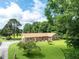 Beautiful brick home with a manicured lawn and mature trees at 1502 Campground Rd, Mcdonough, GA 30252