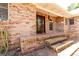 Brick porch, showcasing classic brick steps, dark wood door and arched window at 1502 Campground Rd, Mcdonough, GA 30252