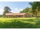Well-manicured front yard presenting a charming brick home with classic architectural details at 1502 Campground Rd, Mcdonough, GA 30252