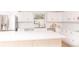 Bright kitchen featuring an island, white cabinetry, and stainless steel appliances at 1502 Campground Rd, Mcdonough, GA 30252