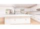 Bright kitchen featuring an island, white cabinetry, and stainless steel appliances at 1502 Campground Rd, Mcdonough, GA 30252