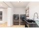Functional laundry room with modern appliances and a utility sink at 1502 Campground Rd, Mcdonough, GA 30252