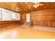 Large Gathering room featuring paneled walls, laminate flooring, and a back door at 1502 Campground Rd, Mcdonough, GA 30252