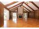 Spacious living room with hardwood flooring, fireplace, wood paneling and a view of the outdoor scenery at 1502 Campground Rd, Mcdonough, GA 30252