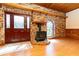 Cozy living area with brick accent wall, a wood burning stove, and stained glass window at 1502 Campground Rd, Mcdonough, GA 30252