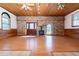 Spacious living room with brick feature, a fireplace, and light wood laminate flooring at 1502 Campground Rd, Mcdonough, GA 30252
