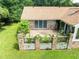 Scenic view of the rear exterior with a brick base, spacious deck, and a lush green lawn at 1502 Campground Rd, Mcdonough, GA 30252