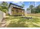 Well-maintained backyard with a covered porch, green lawn, and new wooden fence at 2060 North Avenue Nw, Atlanta, GA 30318
