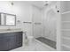 Modern bathroom featuring a sleek vanity, marble floors, and a frameless glass shower with a herringbone tile floor at 2060 North Avenue Nw, Atlanta, GA 30318