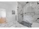 Modern bath featuring marble floors and walls and a frameless glass shower with herringbone tile floor at 2060 North Avenue Nw, Atlanta, GA 30318