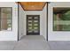Inviting front entrance with a modern black double door and white siding at 2060 North Avenue Nw, Atlanta, GA 30318