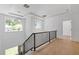 Bright hallway with hardwood floors, modern lighting fixtures, and a staircase with metal railings at 2060 North Avenue Nw, Atlanta, GA 30318
