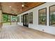 Spacious back porch with wood ceiling, ceiling fans, dark framed windows, and a serene outdoor view at 2060 North Avenue Nw, Atlanta, GA 30318