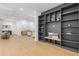 Open-concept living room featuring hardwood floors, a built-in bookshelf, and modern decor at 2060 North Avenue Nw, Atlanta, GA 30318