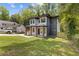 Charming two-story home with landscaped yard, brick accents, modern design, and lush green trees at 2060 North Avenue Nw, Atlanta, GA 30318