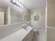 Bright bathroom featuring a wide mirror, vanity, and white tiled shower at 2584 Favor Sw Rd, Marietta, GA 30060