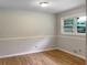 Bright bedroom featuring hardwood floors, fresh paint, chair rail, and natural light at 2584 Favor Sw Rd, Marietta, GA 30060
