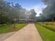 Charming single-story home with long driveway and mature trees on a sunny day at 2584 Favor Sw Rd, Marietta, GA 30060