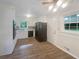 Bright kitchen features white cabinets, wood floors, black appliances and natural light at 2584 Favor Sw Rd, Marietta, GA 30060