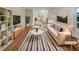 Bright, staged living room featuring a sofa, armchair, rug, and decorative plants at 2584 Favor Sw Rd, Marietta, GA 30060