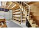Unfinished basement with stairs, exposed wood beams, shelving, lighting, and concrete walls at 2683 Tritt Springs Ne Trce, Marietta, GA 30062