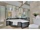 Luxurious bathroom features a large soaking tub, tile surround, and bright glass block accents at 2683 Tritt Springs Ne Trce, Marietta, GA 30062