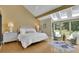 Vaulted ceiling with skylights brighten this bedroom with sitting area, bedside tables, and hardwood floors at 2683 Tritt Springs Ne Trce, Marietta, GA 30062