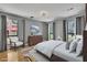 This bright bedroom features a comfortable bed, dresser, and chair for a cozy and inviting space at 2683 Tritt Springs Ne Trce, Marietta, GA 30062