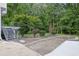 Spacious driveway with steel stairwell to a balcony, mature trees, and landscaping at 2683 Tritt Springs Ne Trce, Marietta, GA 30062