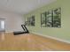 Home gym with hardwood flooring, a treadmill, textured wall, and large windows, offering scenic views at 2683 Tritt Springs Ne Trce, Marietta, GA 30062