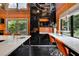 This kitchen features sleek black cabinetry, stainless steel appliances, counter seating, and bright orange accents at 2683 Tritt Springs Ne Trce, Marietta, GA 30062
