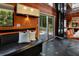 Stylish dining area with black leather bench, orange walls, and access to outdoor deck at 2683 Tritt Springs Ne Trce, Marietta, GA 30062