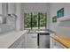 View of kitchenette with stainless steel mini-fridge, wood island, gray cabinets and countertops, and window at 2683 Tritt Springs Ne Trce, Marietta, GA 30062