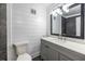 Bathroom vanity with grey cabinet, white counter and shiplap wall at 6700 Roswell Rd # 21E, Sandy Springs, GA 30328
