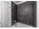 Bathroom bathtub with dark tiled walls at 6700 Roswell Rd # 21E, Sandy Springs, GA 30328